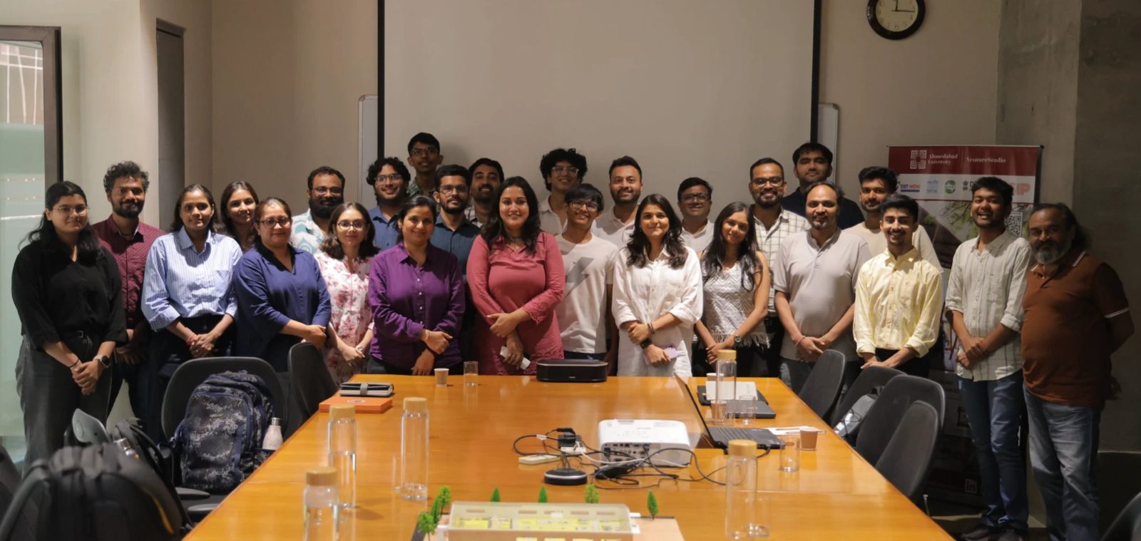 The Startup Round Table at VentureStudio, Ahmedabad University: everyone around the boardroom table. Dhyey is in the middle, in a white t-shirt.