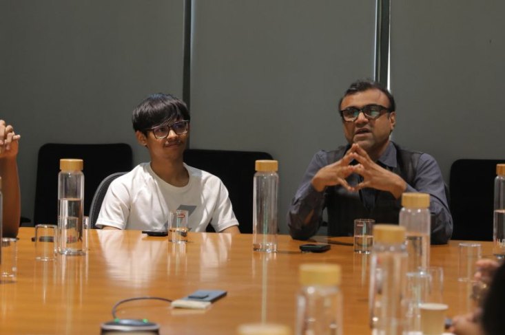 Dhyey at the Startup Round Table, sitting across a boardroom table.